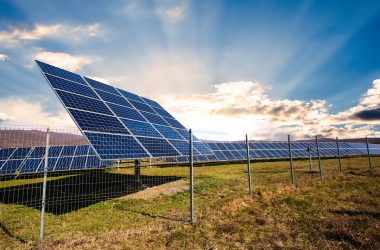 Solar panels against mountains landscape and blue sky